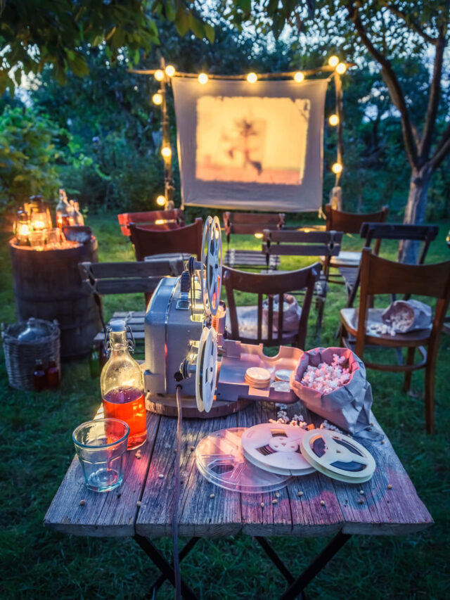 a table with movie snacks outside in front of a screen