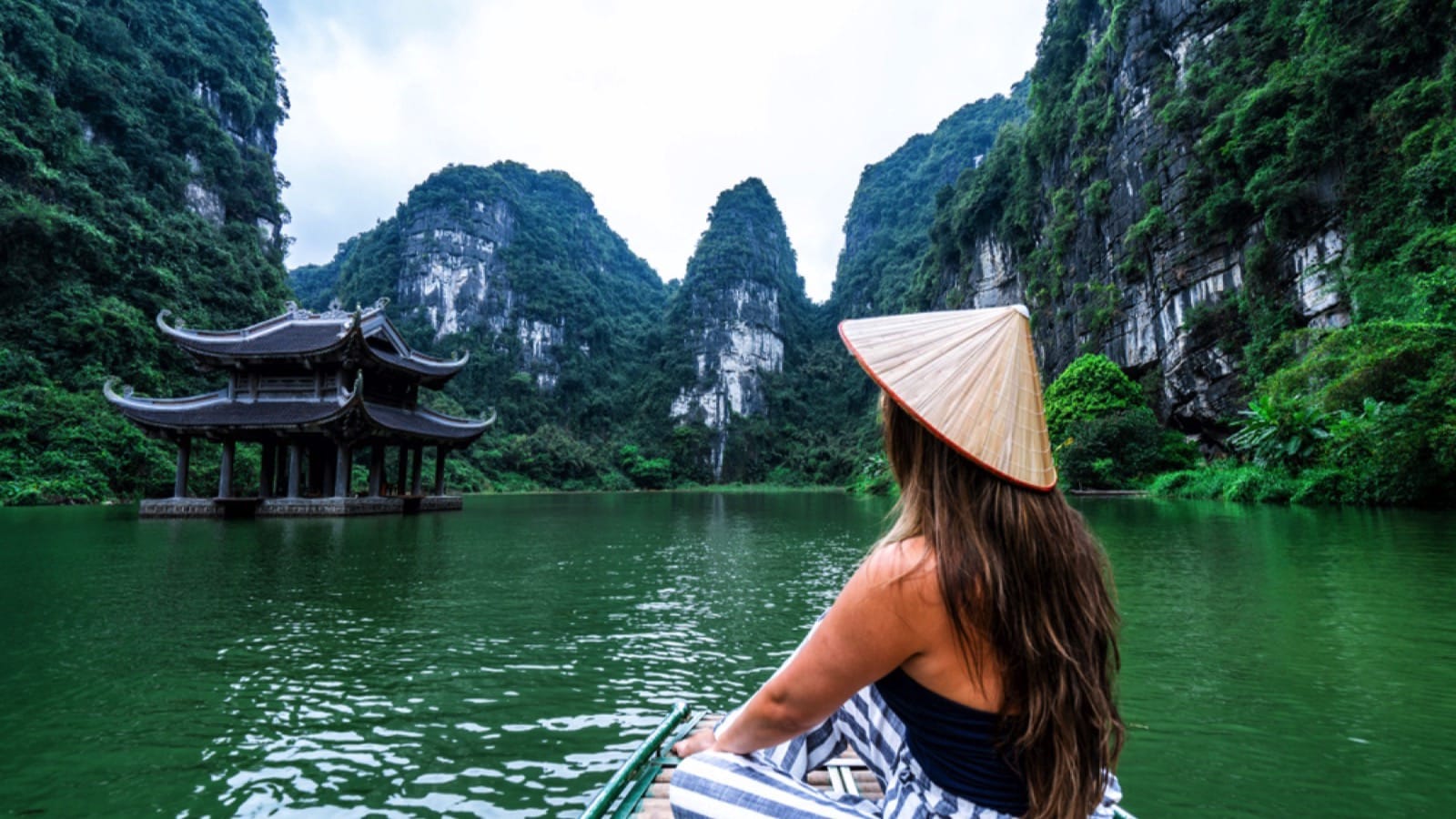 A woman in a river boat in Ninh Binh. Mountains of northern Vietnam