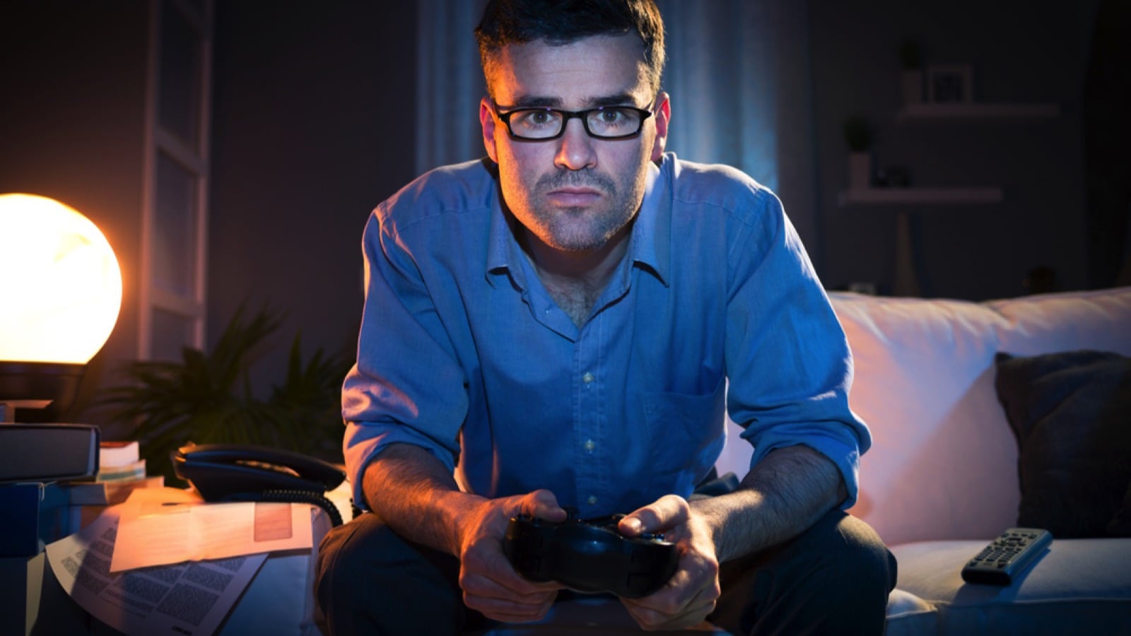 Man playing video game at midnight