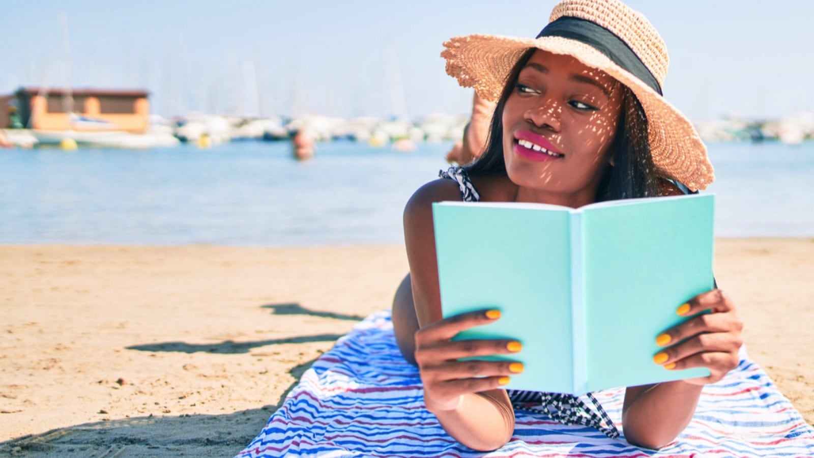 Woman in beach reading book