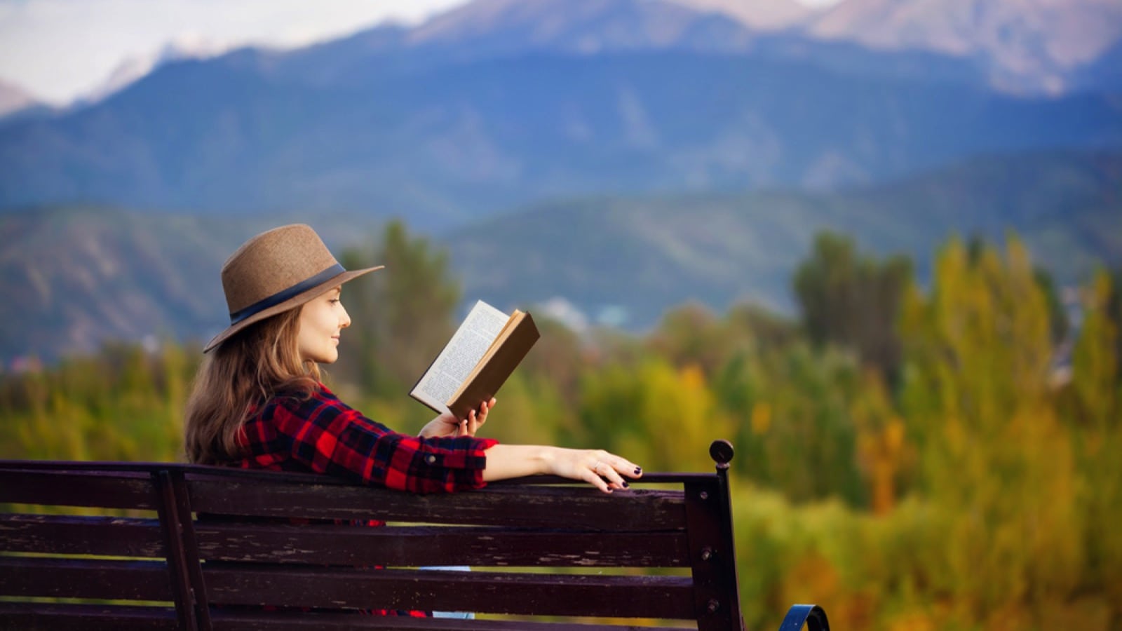 Woman siting in park reading book